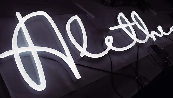 Neon effect LED cursive text storefront signage